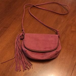 Faux leather shoulder bag with tassel. 2 zip pockets, and one compartment.
